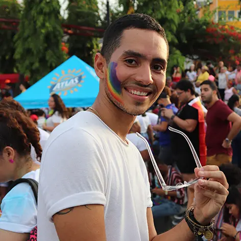 Man with a rainbow on his face smiling