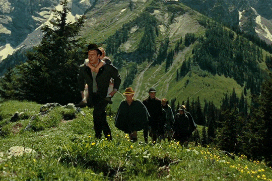 The von Trapp family from the Sound of Music trek up a hill.