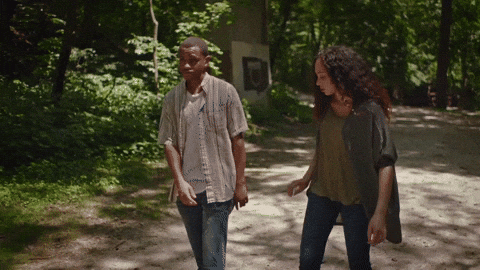 A couple are walking along the path and the woman grab's the man's arm and wraps it around her. Transition from "You never listen" to "I love you"