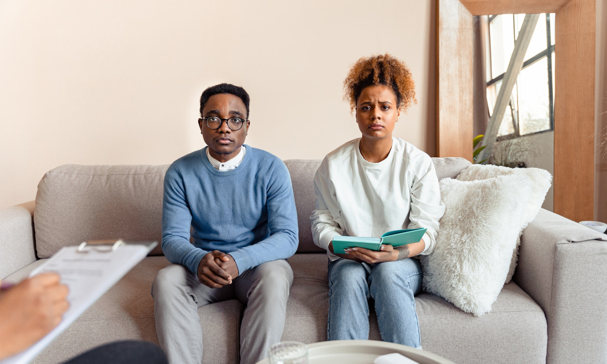 A couple sits on a therapy couch waiting to hear how they can fix their toxic relationship.